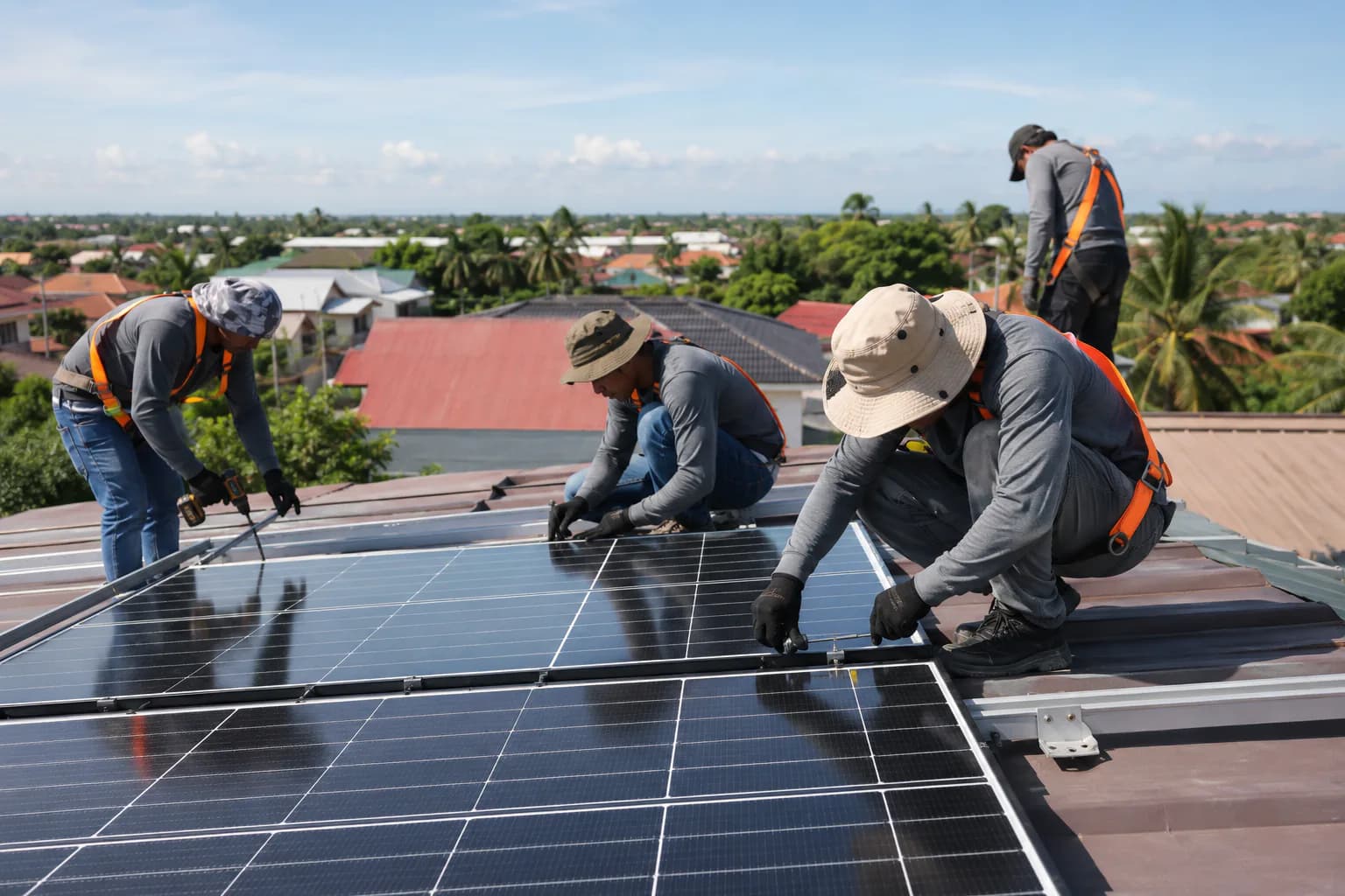 Solar technicians installing rooftop panels on a residential property